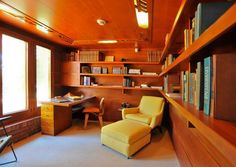 a chair and desk in a room with bookshelves