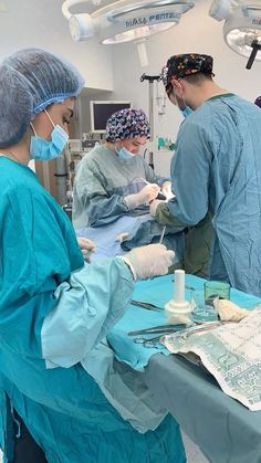 three doctors performing surgery in an operating room