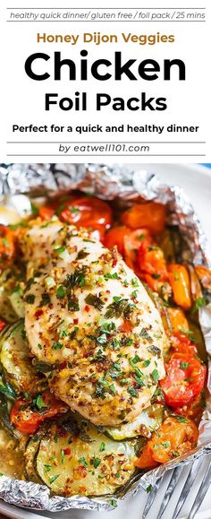 chicken foil packets with tomatoes, zucchini and other vegetables in them on a white plate