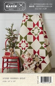 a quilted christmas tree sitting next to a red chair