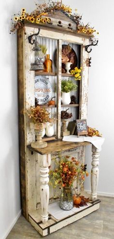 an old cabinet is decorated with fall decorations