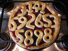 a pie with numbers on it sitting on top of a stove