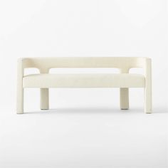 a white bench sitting on top of a white floor