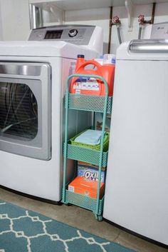 a white washer and dryer sitting next to each other in a laundry room