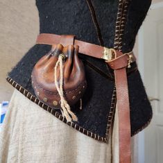 the back of a woman's dress with a leather pouch on it