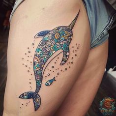 a dolphin tattoo on the thigh