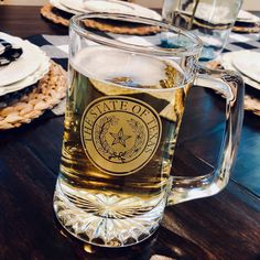 a glass mug sitting on top of a wooden table