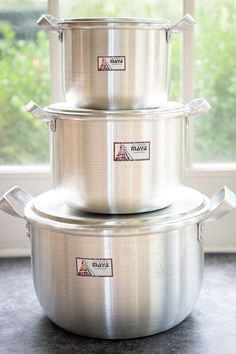 three stainless steel pots stacked on top of each other