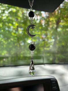 a car dashboard with a wind chime hanging from it's side