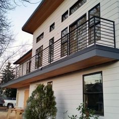 a white house with black railings and windows