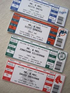 three baseball tickets sitting on top of a table next to each other with the names of their respective teams