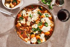 a pan filled with food next to other dishes and utensils on a table