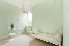 a white room with a couch, table and chair