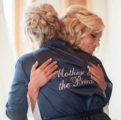 Classy Bride's Mother of the Bride Satin Robe is a thoughtful, luxurious keepsake gift for the mothers on the big day! The MOB will love getting ready in her own custom embroidered satin robe. Our silk-like satin kimono is the ideal gift with its beautiful embroidery detail across the back and amazing fit. It makes this such a personal and thoughtful gift. Classy Bride is know for our quality and attention to detail. We know how important your wedding day is and we enjoy being part of it! Our cu Mother Of The Bride Robe Getting Ready, Mother Of The Bride Robe, Bride Robes, Classy Bride, Custom Robes, Pajama Fashion, The Mob, Bridal Party Robes, Satin Kimono