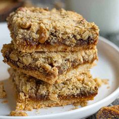 three pieces of granola bars stacked on top of each other in a white plate