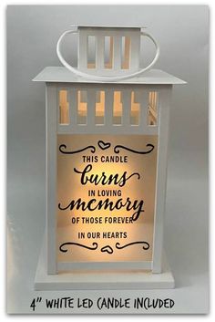 a white candle holder with an inscription on it that says, this candle burns in loving memory