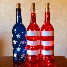 two wine bottles with american flags painted on them