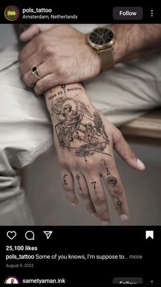 a man's hand with tattoos on it