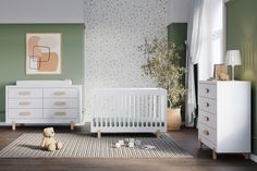 a baby's room with green walls, white furniture and a teddy bear on the floor