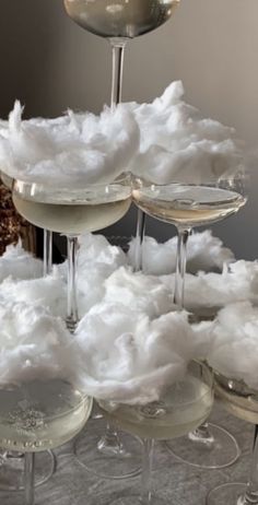 wine glasses filled with white liquid and cotton flakes