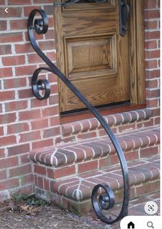 an iron door handle on the side of a brick building