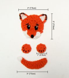 a crocheted red fox head and two feet