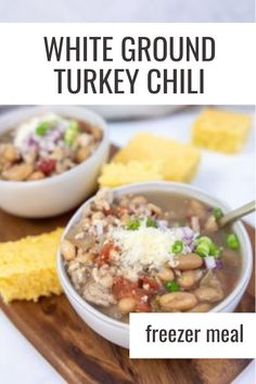 white ground turkey chili in a bowl on a cutting board with tortilla chips