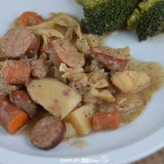 a white plate topped with pasta and sausage next to broccoli florets