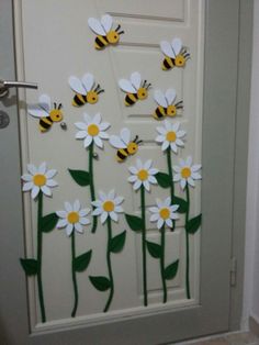 a door decorated with paper flowers and bees