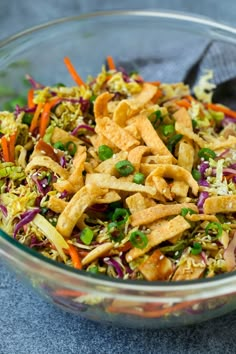 a salad in a glass bowl with a spoon