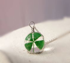 Four leaf clover necklace .Shamrock jewelry St Patricks day gift for her. Now you can have between your hands a magical and authentic four-leaf clover. Take it with you and do you present to awaken in harmony and good luck.This necklace features a small (20mm) solid glass . The length of the chain 24 inches- 3 mm Diameter with a lobster clasp closure. A great gift idea for anyone you think might need some luck or a wish!  The four-leaf clover is an uncommon variation of the common, three-leaved Green Charms Jewelry Perfect For Gifts, Green Flower Pendant Necklace As Gift, Green Flower Pendant Necklace For Gift, Green Flower Charm Round Pendant Jewelry, Green Flower Charm Jewelry With Round Pendant, Nickel-free Green Flower Pendant Jewelry, Green Round Pendant Jewelry With Flower Charm, Green Necklace With Flower Charm And Round Pendant, Green Jewelry With Flower Charm As Gift