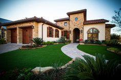 a large house with landscaping in front of it