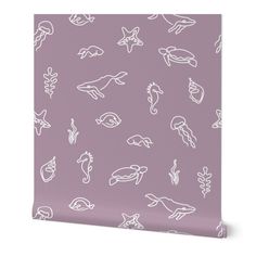 a purple wall with white sea animals on it