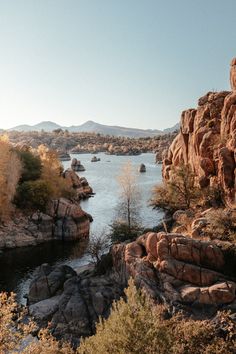 a lake surrounded by rocky mountains and trees