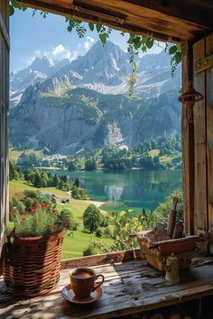 an open window with a view of mountains and lake