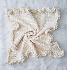 a crocheted baby blanket with the words marshmallow clouds written on it