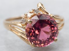 A stunning statement piece, this ring will turn heads! The perfect combination of sweet and sophisticated, this ring features a dazzling pink tourmaline surrounded by gleaming diamond accents. Metal: 14K Yellow GoldGem: Pink Tourmaline 4.21 CaratsGem Measurements: 9.7 mm, RoundAccents: 3 Diamonds totaling .06 Carats, I in Clarity, H-I in ColorRing Size: 8.25Marks: "(C) T&G 14KP" Stamped on the inside band Ornate Ring, Pink Stone Rings, Filigree Ring Gold, Attic Storage, Pink Tourmaline Ring, Sparkly Jewelry, Tourmaline Ring, Pink Gemstones, Gold Filigree