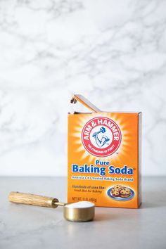 a box of baking soda sitting on top of a counter next to a rolling pin