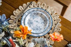 a blue and white plate sitting on top of a wooden table