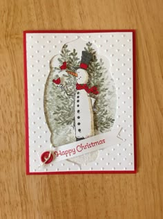 a christmas card with a snowman on it