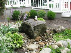 a rock in the middle of a garden