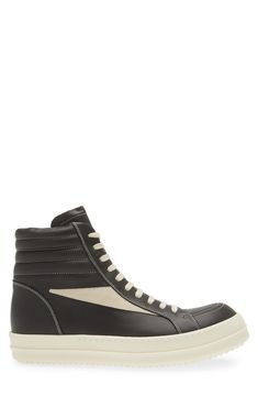 Crafted from full-grain leather and suede, this high-top sneaker is quintessentially Rick Owens with its blunted toe, dramatic lacing and shark-tooth sole. Drawing inspiration from vintage silhouettes and color schemes, this boldly topstitched shoe blends modern comfort with a timeless aesthetic. Lace-up style Leather upper and lining/rubber sole Made in Italy Designer Shoes Leather High-top Sneakers With Vulcanized Sole For Streetwear, High-top Sneakers With Leather Sole, Leather High-top Sneakers With Rubber Sole For Streetwear, Leather High-top Boots With Vulcanized Sole, High-top Leather Sneakers With Gum Sole, Modern High-top Sneakers With Leather Sole, Calf Leather High-top Sneakers With Rubber Sole, Designer High-top Sneakers With Vulcanized Sole, Suede High-top Sneakers With Gum Sole