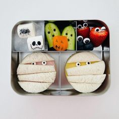 a bento box with some food in it that looks like faces and eyes on them