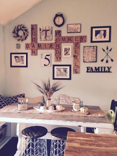 a dining room table with chairs and pictures on the wall above it that says family