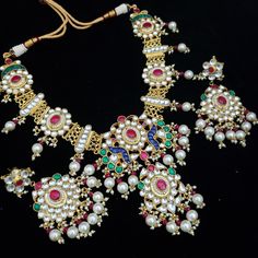 Kundan jewelry is 100% Handmade Indian Jewelry, best to wear it for traditional ceremonies or Indian weddings. This bridal jewelry has an ethnic finish. It has Polki Kundan stones with pearls in pink and green combinations. There are long and short patterns in Kundan jewelry. They give a glamorous outlook to traditional outfits. It has a Bollywood style to suit every occasion and goes really well with South and North Indian weddings. Color, shades, texture displayed may slightly vary from the ac White Kundan Jewelry For Traditional Ceremonies, Heavy Chandbali Bridal Necklace For Festivals, Elegant Meenakari Bridal Necklace For Traditional Ceremonies, White Traditional Choker For Ceremonial Occasions, Traditional White Choker For Ceremonial Occasions, Traditional Heavy Lehenga For Festivals, Traditional White Ceremonial Choker, Gold Kundan Necklace With Meenakari For Traditional Ceremonies, Heavy Kundan Bridal Necklace For Traditional Ceremonies