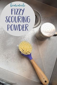 a yellow and blue brush sitting on top of a metal sink