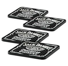 three black and white coasters with the words jack daniels on them, set of four