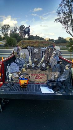 the back of a truck is decorated with skeletons and tombstones, including two jack - o'- lantern heads