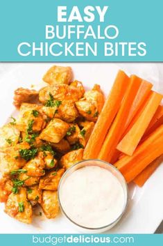 buffalo chicken bites with ranch dressing and carrots on a white plate next to a small bowl of ranch dressing