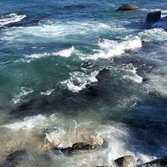 the water is very choppy and blue with some waves coming in to shore on it